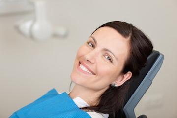 woman sitting in dentist exam chair | laser dentistry goffstown nh