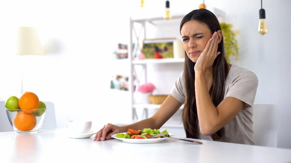 woman in pain holding jaw | botox for jaw pain near me
