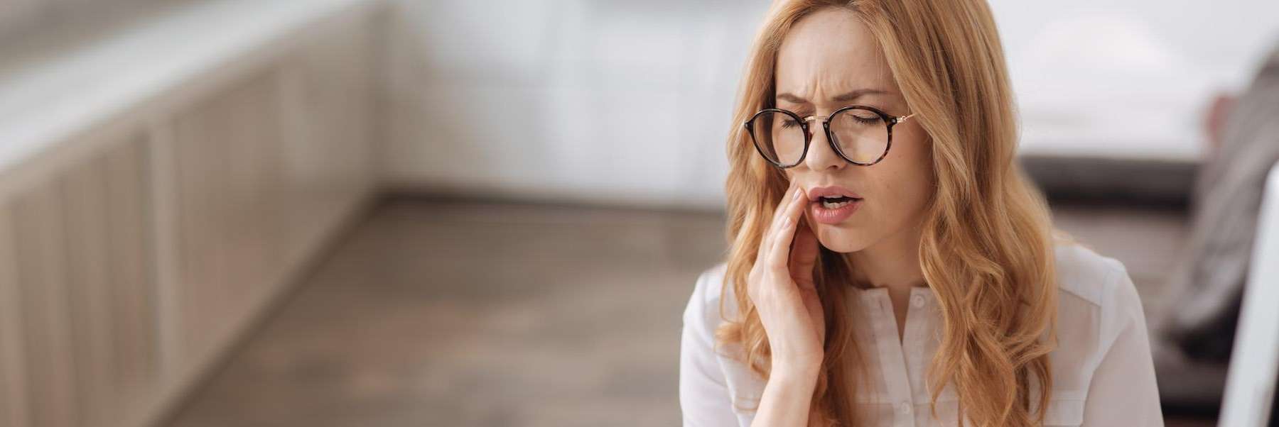woman with glasses in pain | botox goffstown nh
