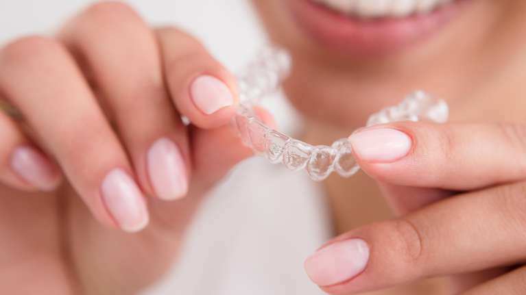 woman holding Invisalign