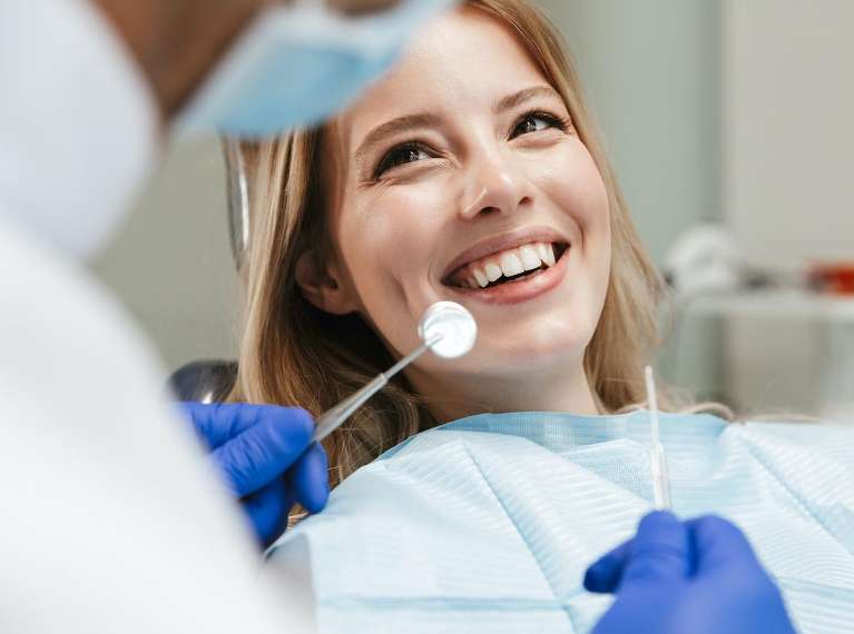 woman smiling in exam chair | goffstown dental
