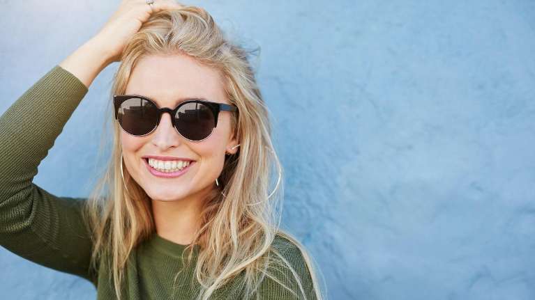 woman with blonde hair smiling | dentist near me