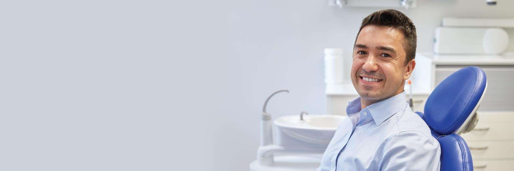man sitting in dentist exam chair | goffstown dentist