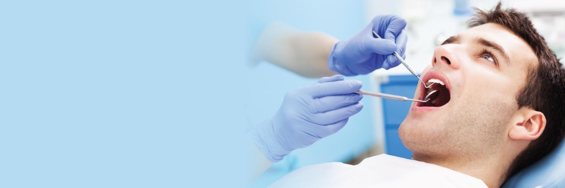 man getting dental cleaning l dental crowns goffstown nh