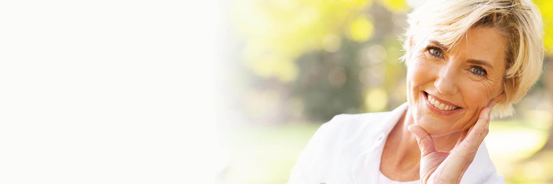 woman with short blonde hair smiling l dental implants goffstown nh